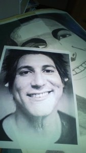 You can see the original picture on top of the artist's work.  